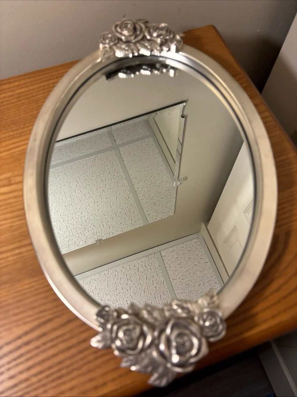 Elegant Silver Oval Wall Mirror with Rose Accents